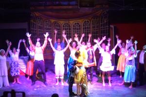 a group of people on a stage with their hands in the air at Corvino Resort in Monopoli