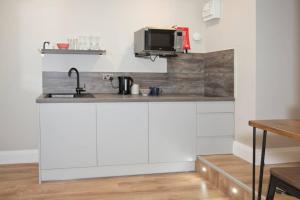 a kitchen counter with a sink and a microwave at Blackbird Luxury 2 Bed Accommodation Room 7 in Blackpool