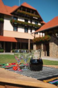 a table with two wine glasses on a table at VILLA GHERMAN in Sălciua de Jos