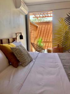 a bedroom with a large bed with a large window at BOMA LifeStyle Hotel in Dakar