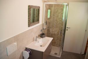 a bathroom with a sink and a shower at Sole Agriturismo in Locatello