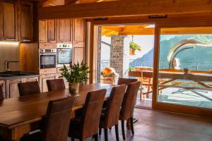 a kitchen with a wooden table and chairs and a dining room at Sole Agriturismo in Locatello +28 photos