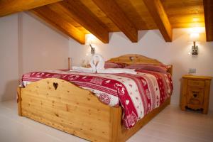 a bedroom with a large wooden bed in a room at Sole Agriturismo in Locatello