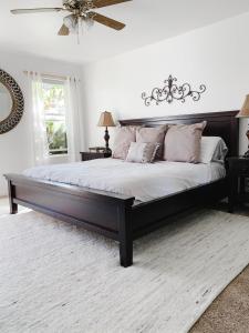 a bedroom with a large bed with a wooden headboard at Bryce Countryside Residence in Tropic