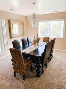 a dining room with a black table and chairs at Bryce Countryside Residence in Tropic