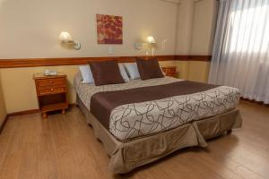 a bedroom with a large bed and a wooden floor at Aguas Del Sur in San Carlos de Bariloche