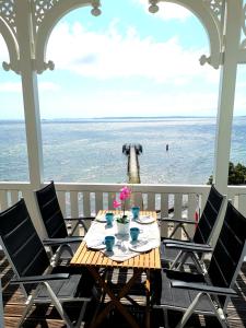 a table on a porch with a view of the ocean at Fürstenhof Fewo Beagle in Sassnitz
