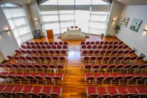 un auditorium vide avec des chaises rouges et une scène dans l'établissement Patagonia Sur Hotel, à San Carlos de Bariloche