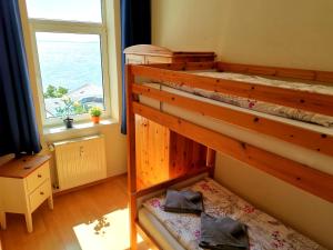 a bunk bed in a room with a window at Fürstenhof Fewo Beagle in Sassnitz