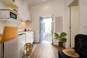 a living room with a kitchen and a dining room at Alfama Yellow House in Lisbon