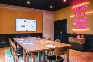 a conference room with a table and a sign that reads today is a good day at Moxy Paris La Villette in Paris