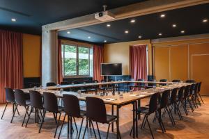 a large conference room with a long table and chairs at Moxy Paris La Villette in Paris