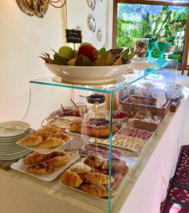 a display case filled with different types of pastries at Hotel Santa Caterina in Siena