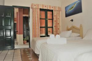 Postel nebo postele na pokoji v ubytování Hotel Belmar