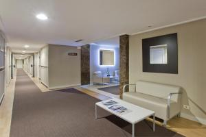 a lobby with a couch and a table at Hotel Abando in Bilbao