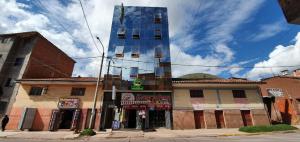 a tall building on the corner of a street at Hostal Ukumari Andino in Cusco