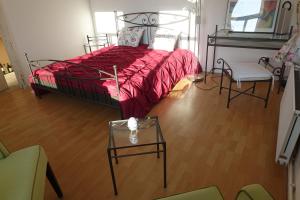 a bedroom with a bed and a table and chairs at Hotel Alpenblick in Todenbüttel