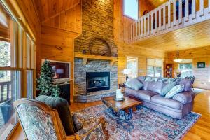 a living room with a couch and a fireplace at Mountain Laurel View in Blue Ridge