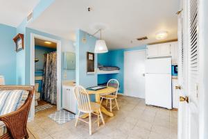 a kitchen with a table and chairs and a refrigerator at Myrtle Beach Resort in Myrtle Beach