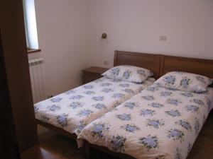 a bedroom with a bed with a floral comforter at Tourist Farm Petelin-Durcik in Pliskovica