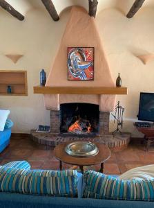 a living room with a fireplace with a blue couch at Casa Mola in Perelló