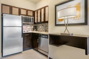 a kitchen with a refrigerator and a lamp on a counter at Staybridge Suites St. Petersburg FL, an IHG Hotel in St Petersburg