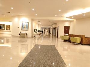 a lobby of a hospital with a hallway with chairs at Grand Service Apartment @ Times Square in Kuala Lumpur