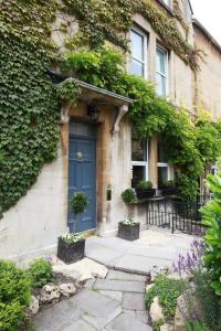 a blue door on the side of a house at Brindleys in Bath