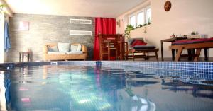 a large swimming pool in a living room at Bed & Breakfast Crosne Plazza & Spa in Crosne