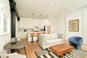 a living room with a couch and a table at Sonder The Saddlery in Nashville