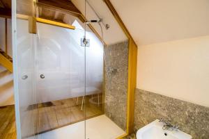a bathroom with a glass shower and a sink at Camere Bar Rudi in Santa Maria Maggiore