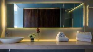 a bathroom with a sink and a mirror at PIER 57 - 208 Best 2 BR Condo in Romantic Zone in Puerto Vallarta