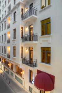 an external view of a building with a red awning at The Rooms Nisantasi in Istanbul