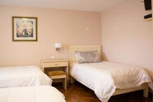 Voodi või voodid majutusasutuse Hotel Sandmelis toas