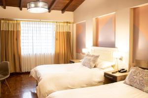 Voodi või voodid majutusasutuse Hotel Sandmelis toas