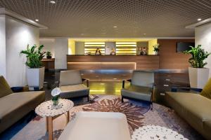 a lobby with couches and chairs and a table at Crowne Plaza Milan Linate, an IHG Hotel in San Donato Milanese