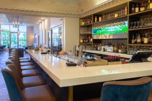 a bar with chairs and a long counter at Crowne Plaza Fredericton Lord Beaverbrook by IHG in Fredericton