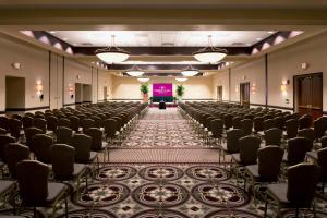 an empty room with rows of chairs and a stage at Crowne Plaza Greenville by IHG in Greenville +58 photos