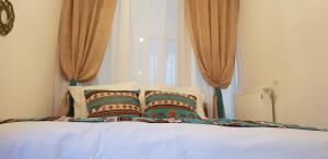 a bed with two pillows and a book on it at Apartman ZELENA BAJKA- Bjelašnica in Bjelašnica