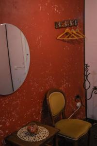 a bathroom with a chair and a mirror at FACTORY Hostel in Kyiv