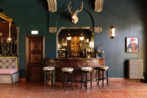 a bar with stools in a room with a mirror at Palihouse Santa Monica in Los Angeles
