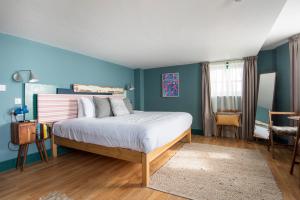 a bedroom with a bed and a desk at Selina Brighton in Brighton & Hove