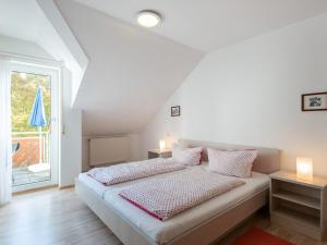 ein Schlafzimmer mit einem Bett mit zwei Kissen und einem Fenster in der Unterkunft Simplistic Apartment in Bad D rrheim with Garden Balcony in Bad Dürrheim