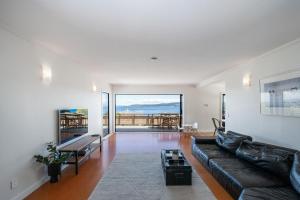 a living room with a couch and a view of the ocean at Lakeview Lookout in Taupo
