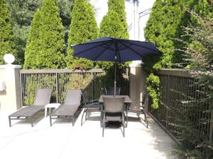 a patio with a table and chairs and an umbrella at Holiday Inn Express Trussville, an IHG Hotel in Trussville