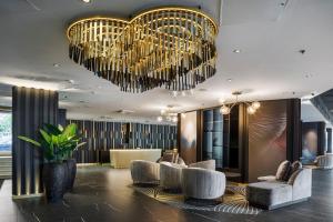 a lobby with chairs and chandeliers at Crowne Plaza Helsinki - Hesperia, an IHG Hotel in Helsinki