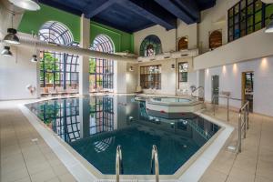 a large indoor pool with a tub in a building at Crowne Plaza Leeds by IHG in Leeds