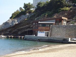 a house on the shore of a body of water at Hotel George in Agios Kirykos