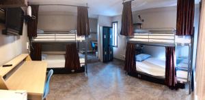 two bunk beds in a room with a desk at Banff International Hostel in Banff +37 photos