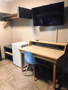 
a kitchen with a table and a refrigerator at Banff International Hostel in Banff
